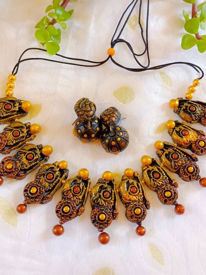 An antique copper and gold version of the temple necklace, offering a muted, earthy color palette.