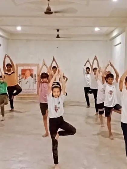 We incorporate yoga into our training to improve balance and focus. Here, students are practicing Vrikshasana (Tree Pose).