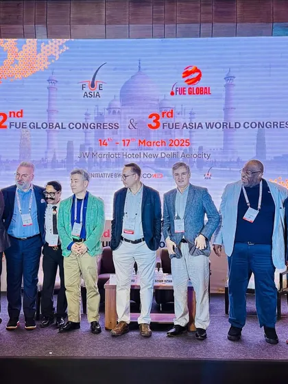 A group photo with esteemed colleagues on stage at the 2nd FUE Global Congress & 3rd FUE Asia World Congress. These events are vital for sharing knowledge and advancing the field of hair restoration.