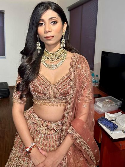 The full look is understated yet incredibly elegant. The simple hair and makeup allow the intricate outfit to be the main focus.