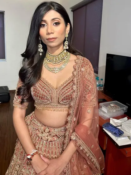 The full look is understated yet incredibly elegant. The simple hair and makeup allow the intricate outfit to be the main focus.