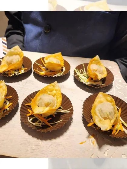 Crispy fried Chicken Wontons, served on a bed of shredded carrots. These savory bites are a popular choice for cocktail parties and events.