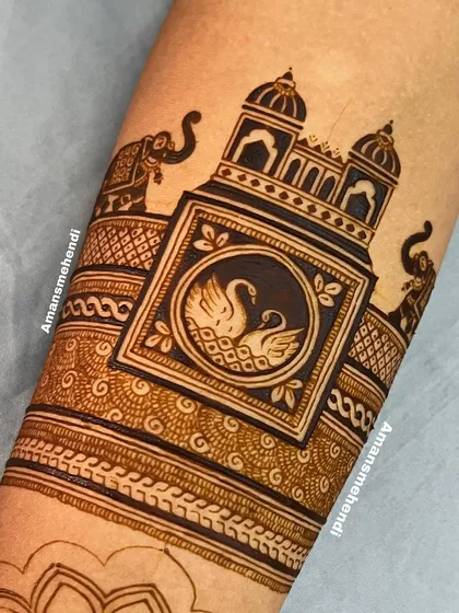 The design taking shape with a central swan motif inside a frame. The surrounding bands feature intricate jaali work and traditional patterns.