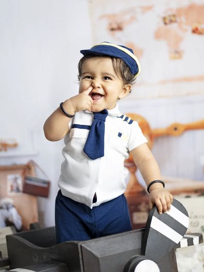 This cheeky pilot is ready for takeoff. We love capturing these funny, personality-filled moments during our themed shoots.