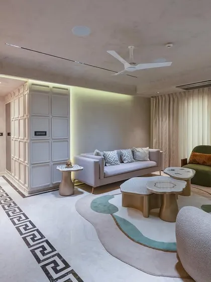 This living room showcases our expertise in modern, elegant interiors. We used a neutral palette with organic forms, like the curved sofas and uniquely shaped coffee tables, to create a space that feels calm and sophisticated. The design balances high-end luxury with a serene, nature-inspired atmosphere.