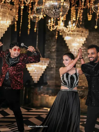 This is what it looks like when I join the couple on the dance floor. I’m not just an MC behind a mic; I’m right there with you, matching your energy and making sure every moment is filled with joy. This Sangeet night was electric, under a sky of chandeliers and disco balls.