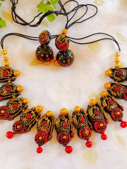 This red and black version of the temple necklace is a bold and classic combination, perfect for pairing with traditional silk sarees.