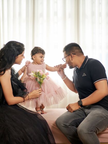 A sweet moment between parents and their little one. Our black ballgown provides a dramatic and elegant base for family photos.