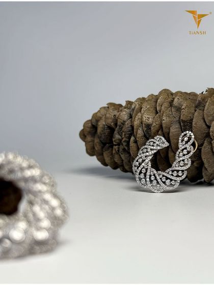 Inspired by the flow of leaves and vines, these diamond hoop earrings shimmer like morning dew, delicately sculpted in gold.