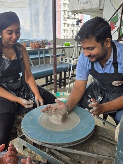 A moment of concentration and collaboration. This couple is working together to get the feel of the spinning clay, one of the first steps in our hands-on pottery session.