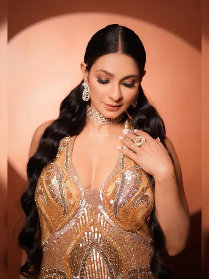 A beautiful close-up focusing on the details of the gown's bodice and the stunning jewelry. The soft, downward gaze adds a touch of demure elegance.