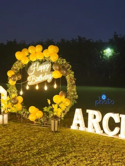 The stunning outdoor setup for a 60th birthday party, featuring large light up letters and a festive balloon wreath.