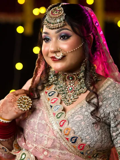 A profile view of the festive bridal look, showing how the makeup and hair come together to create a complete, polished look.