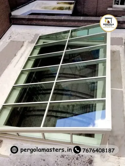 An angled glass skylight or conservatory roof, designed to fit a sloped roofline. This type of structure is perfect for bringing maximum light into an attic conversion or extension, creating a bright and airy space.