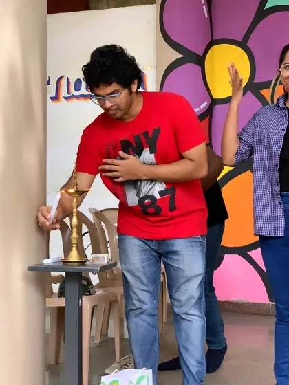 A volunteer lights the lamp at Sign Fest, marking the beginning of a day dedicated to celebrating Deaf culture and Indian Sign Language.