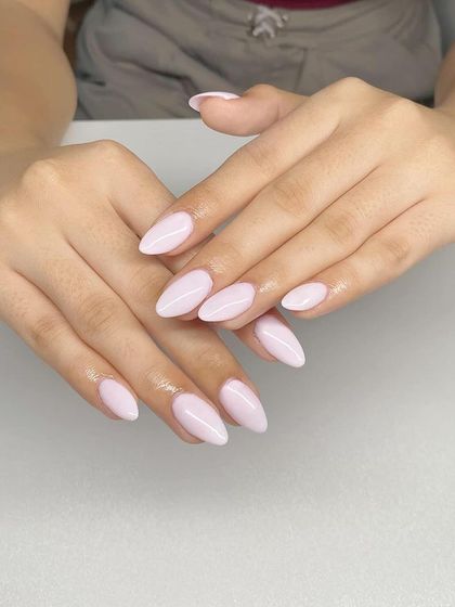 A simple and elegant set of almond-shaped extensions with a solid, soft pink gel polish. Perfect for a subtle and professional look.