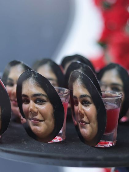 A fun and personal touch: custom stirrers featuring the bride's face for the party's signature shots.