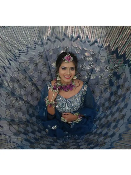 A creative shot showing the beautiful flare and intricate pattern of the teal and silver lehenga. It’s a fun and photogenic outfit, perfect for capturing memories.