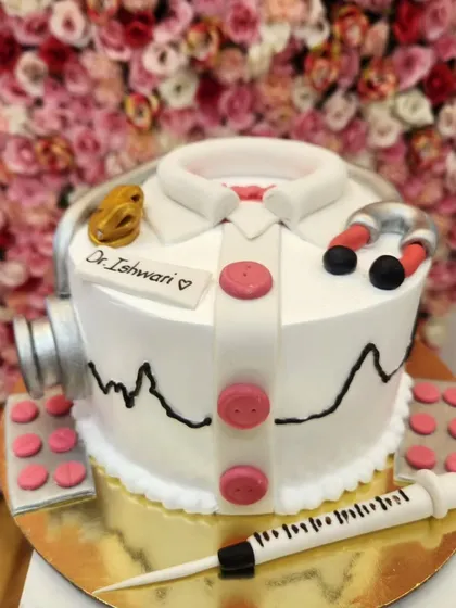 A special cake for a special professional. This doctor-themed cake features a fondant stethoscope, syringe, and pills, all edible and crafted with precision to celebrate a medical milestone.