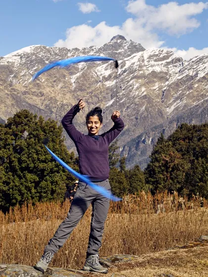 A powerful still image of me spinning poi against a snow-capped mountain, showcasing another flow art I teach. This moment captures the feeling of connecting with the universe through movement.
