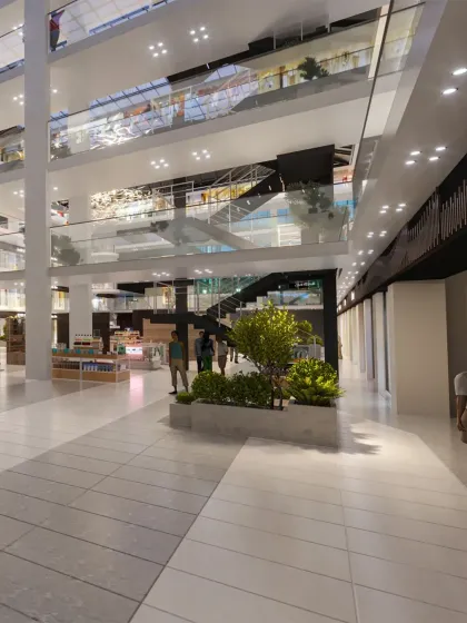 The interior of the mall features a multi-story atrium with integrated planters and clear sightlines across different levels, promoting circulation.