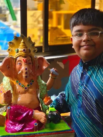 One of our youngest students with the Ganpati idol he painted. Our workshops are family-friendly, offering a creative and spiritual experience for all ages during the festival season.