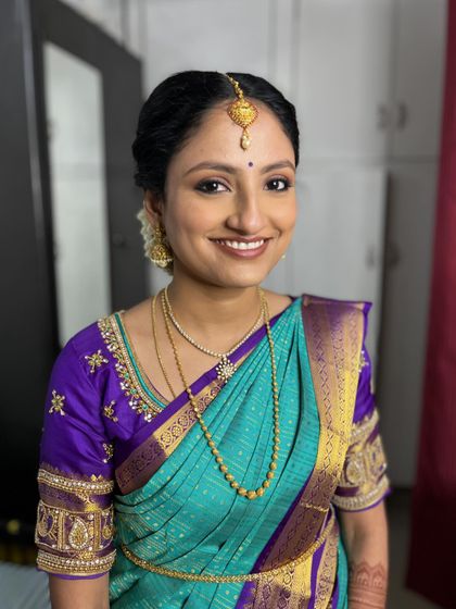 Harini's radiant smile. The makeup is understated and classic, perfect for a traditional pre-wedding ceremony.