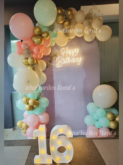 A sweet 16 celebration with a beautiful pastel balloon garland. The large light-up '16' makes a perfect centerpiece for photos.