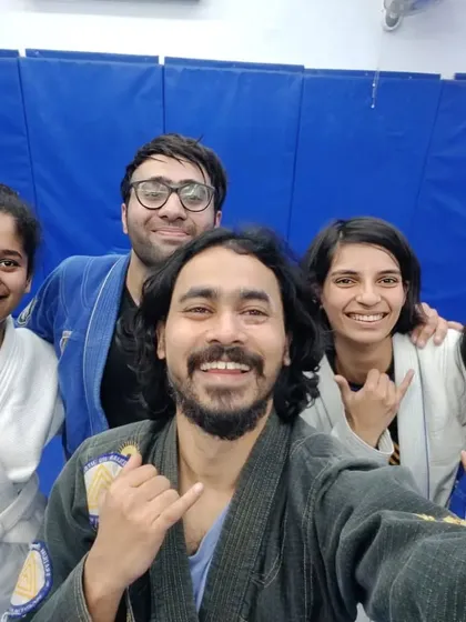 A cheerful group selfie with students in blue and white Gis after a challenging class.