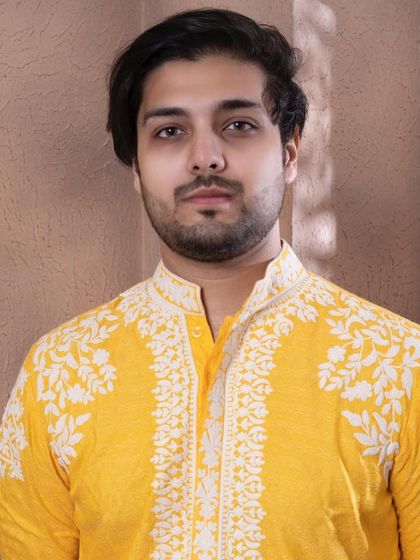 A close portrait in the zesty yellow kurta, focusing on the detailed embroidery around the collar.