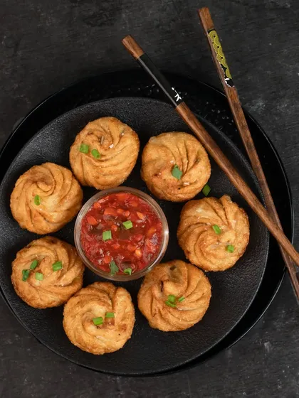 Another shot for Momos Corner, this time focusing on the texture and shape of their fried momos, arranged neatly on a plate.