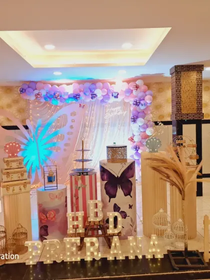 Another perspective of the butterfly theme, showing the intricate details like the bird cages, pampas grass, and custom-printed plinths.