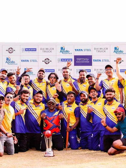 Celebrating success is a key part of every event we organize. Here, a winning team from the Indian Corporate Cricket League poses with their trophy in front of a sponsor wall featuring brands like Daimler Truck, Apollo Hospitals, and Tata Steel.