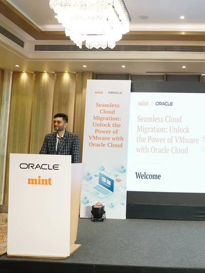 A wide shot of the stage at the Oracle and Mint summit. I am experienced in managing large stages and ensuring a smooth experience for both speakers and attendees.