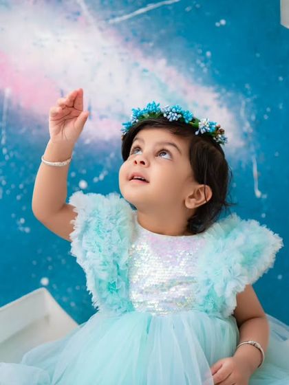 Reaching for the galaxy. This pose captures a sense of wonder and imagination, perfect for the dreamy moon and stars theme.