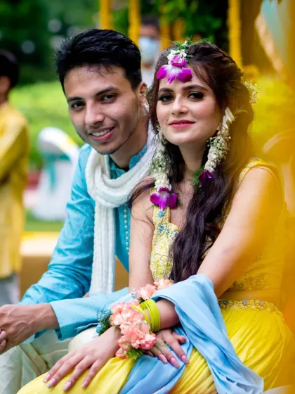 A sweet portrait of the couple, framed by the yellow decor of their haldi event.