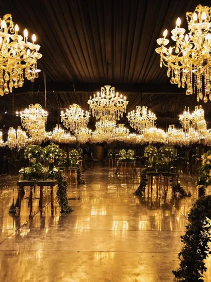 I believe in creating immersive worlds for your celebration. This Sangeet hall features a breathtaking ceiling of countless chandeliers and florals, reflecting my commitment to large-scale, luxurious decor that leaves guests in awe.