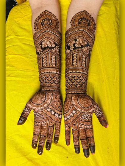 A full-arm design with a mix of bold architectural shapes and delicate floral patterns. The contrast between the dark-filled areas and fine lines is striking.