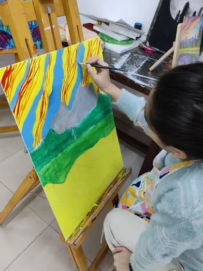 Follow a student's progress on a vibrant landscape painting, showing the development from a simple sketch to a fully colored and detailed scene.