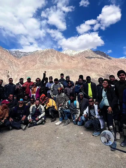 The whole group together against the mighty mountains. You come for the trip, you leave with a family.