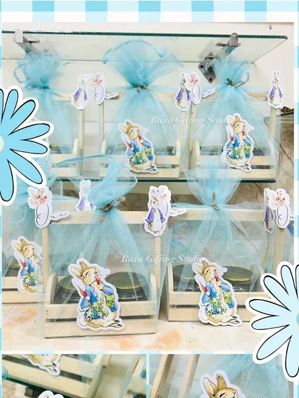 A closer look at the Peter Rabbit hampers, featuring cute character cutouts and soft blue net wrapping for a whimsical feel.