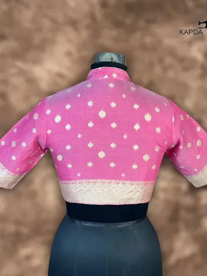 This Banarasi pink brocade blouse is a royal and traditional piece. The intricate brocade work and elegant zari embroidery give it a unique and timeless look, perfect for a wedding or sangeet.