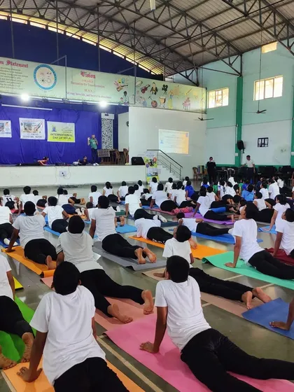 A large group of students practicing Bhujangasana (Cobra Pose) in a hall in Goa. Our goal is to take the benefits of Yoga to every corner of the country.