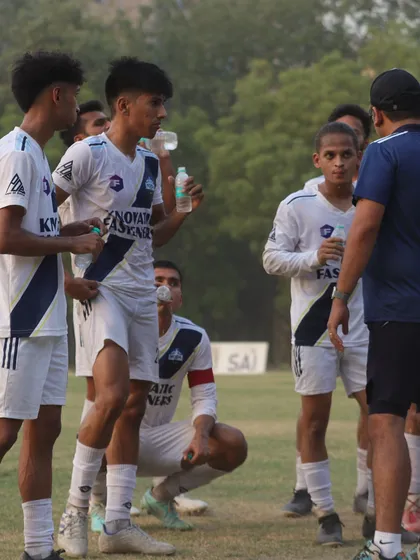 Players taking a water break while receiving instructions from the coach. We emphasize strategy and communication during training and matches.