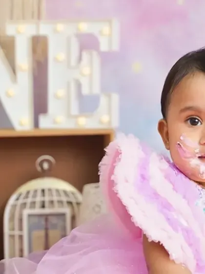 A close-up of the birthday girl with a little bit of cake on her face. These are the cute, messy details we love to capture.