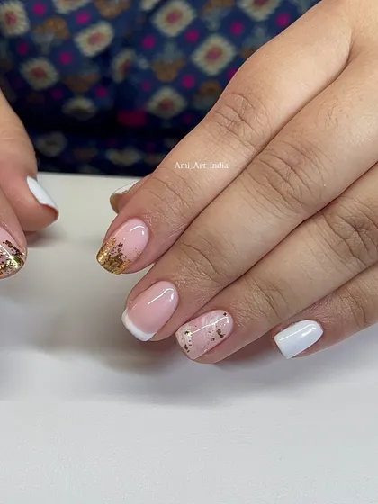 This elegant set combines a French manicure with trendy gold flake accents.