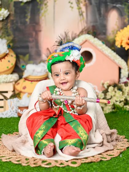 Another adorable Little Krishna, smiling brightly for the camera. The details, from the turban to the flute, all come together to create a magical portrait.