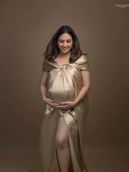 Another elegant look from the same maternity shoot. The simple makeup and hair allow the unique satin draping and her pregnancy glow to be the main highlights.