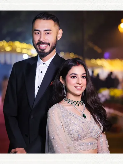 A formal portrait of the couple, smiling for the camera. This image is perfect for announcements, capturing their happiness and the celebratory feel of their engagement night.