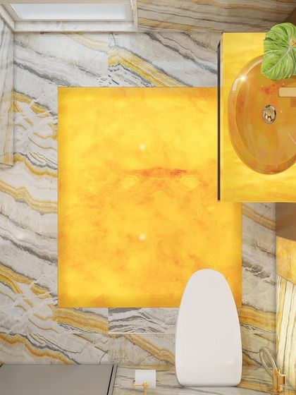 A top-down view of the honey onyx bathroom, showing the illuminated floor panel and the custom onyx sink. This design uses light and material to create a truly unique experience.